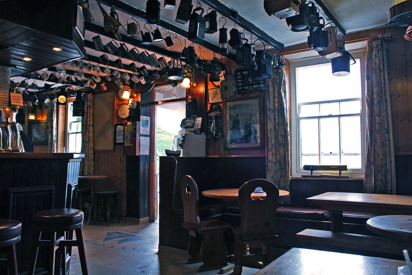 Inside the Tŷ Coch Inn at Porthdinllaen, lanterns and maritime memorabilia hanging from the beams.