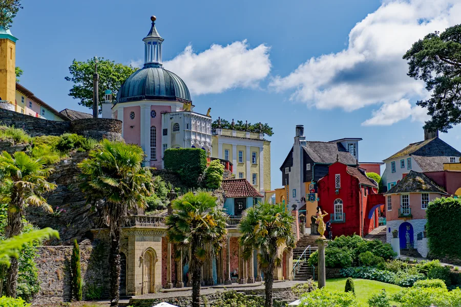 The domed Pantheon and painted Italianate houses of Portmeirion, rising above palms and terraced gardens.