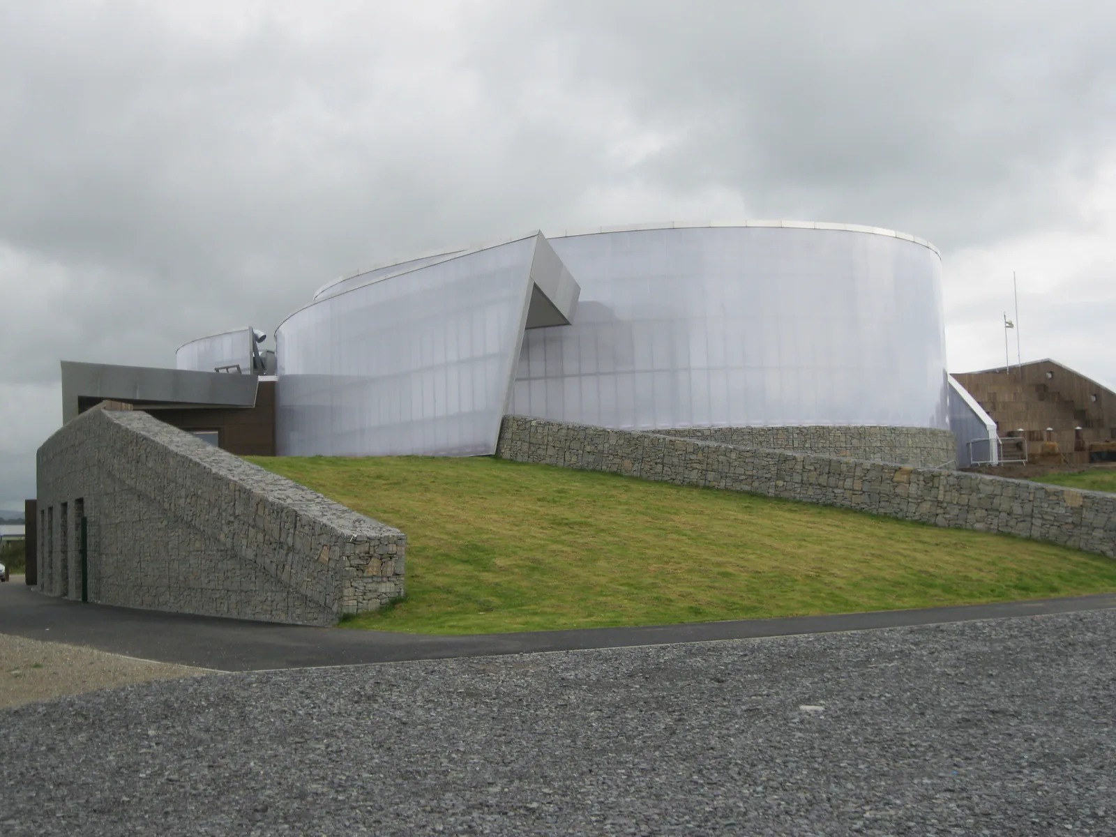 The curved translucent form of Plas Heli seen from the quay road