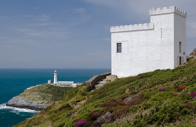 South Stack Lighthouse on its green-topped island below the cliffs of Holy Island, seen from Elin's Tower country on the headland.