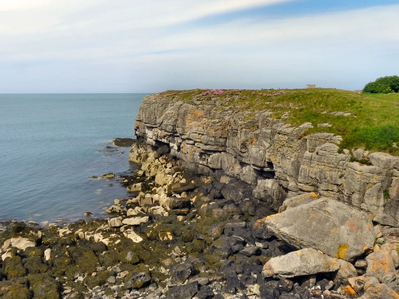 The rugged coastline between Moelfre and Lligwy: sea, rock and the edge of the bay.