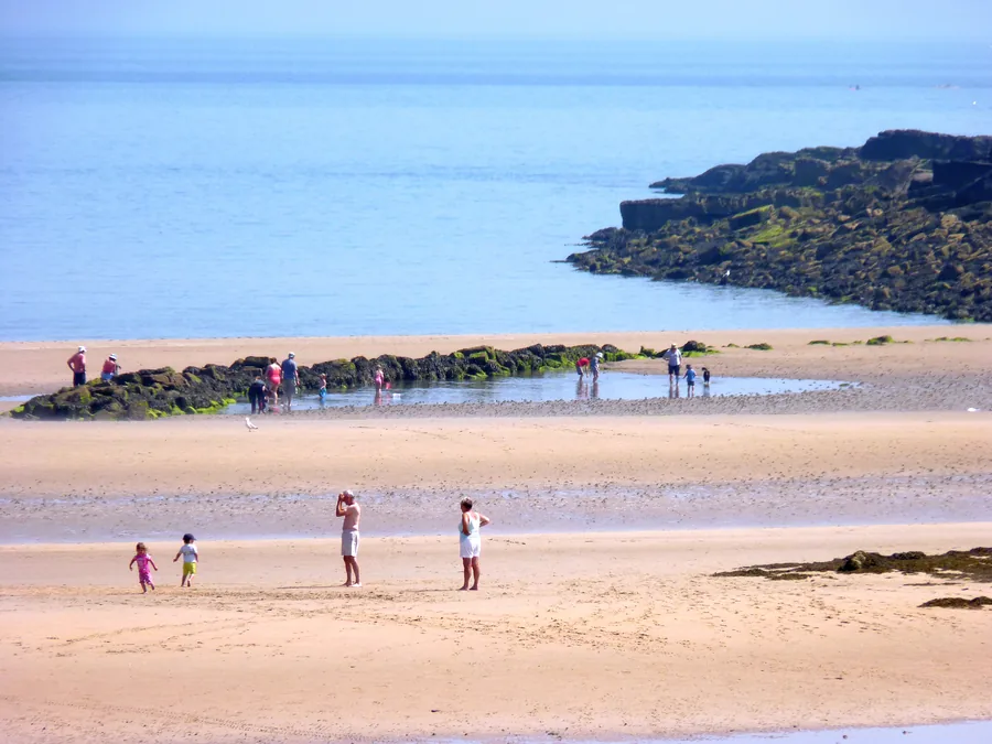Low limestone cliffs above the pale sands near Traeth Lligwy on the east coast of Anglesey.