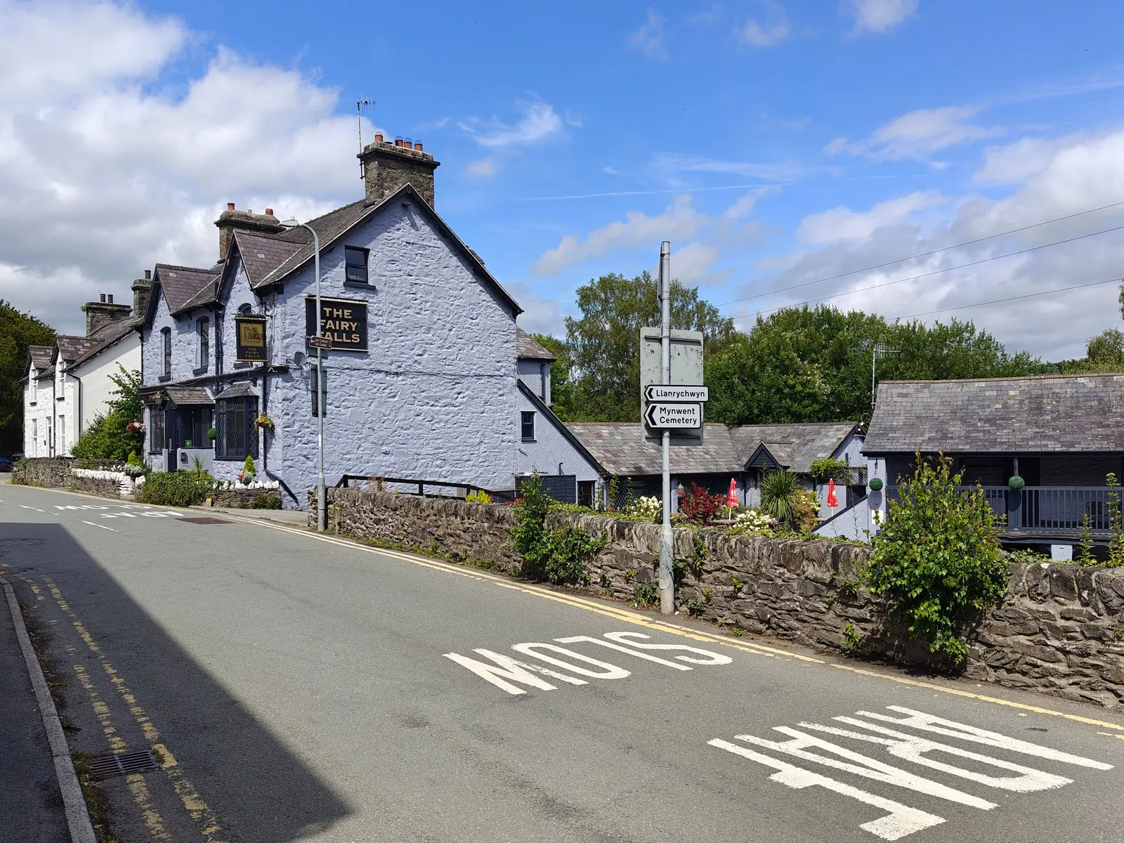 The junction in the centre of Trefriw where the lake road leaves the main road beside the pub