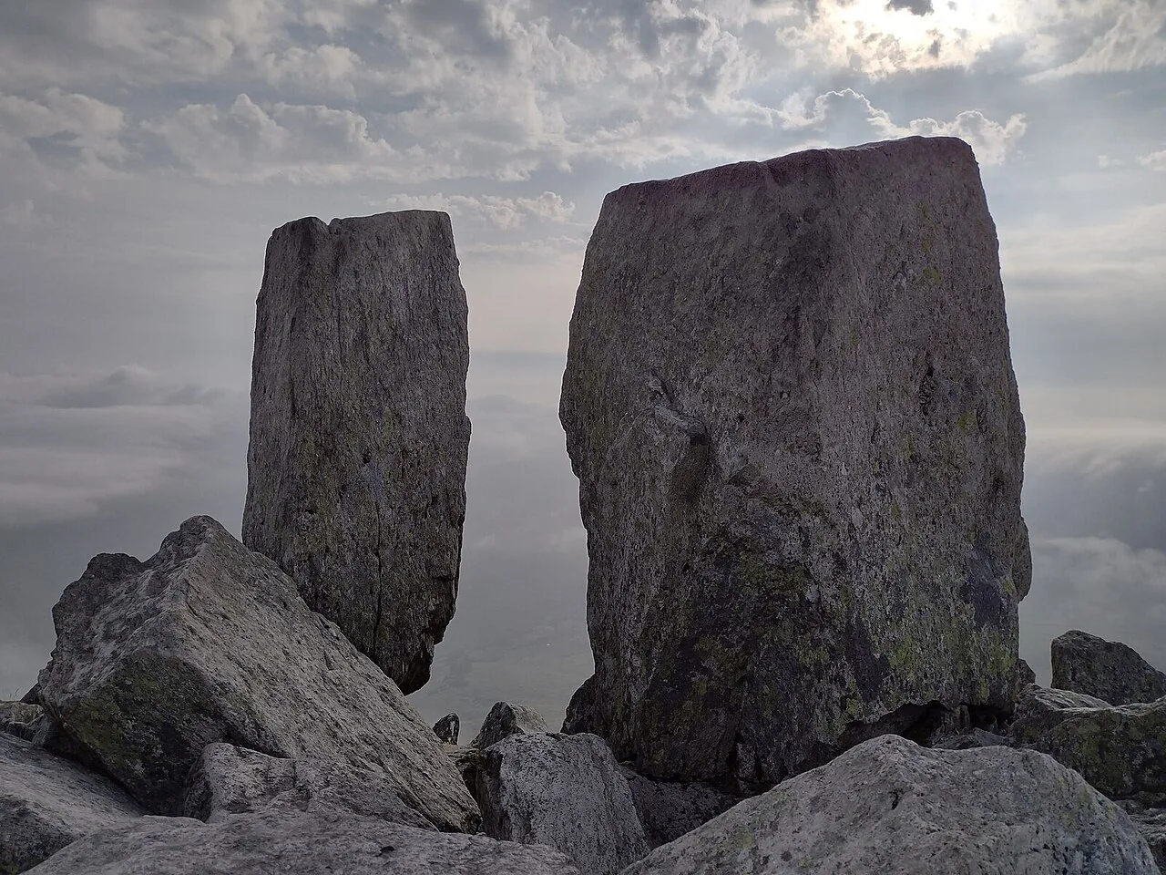 Adam and Eve, the twin summit rocks of Tryfan, standing a stride apart with cloud filling the valley below
