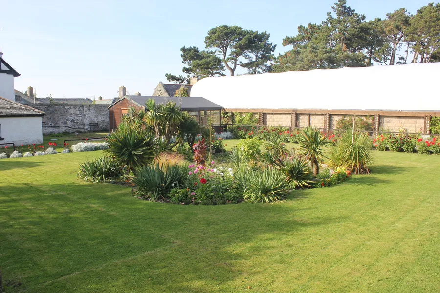 A landscaped garden with palms and flowerbeds at the Welsh Mountain Zoo, Colwyn Bay.