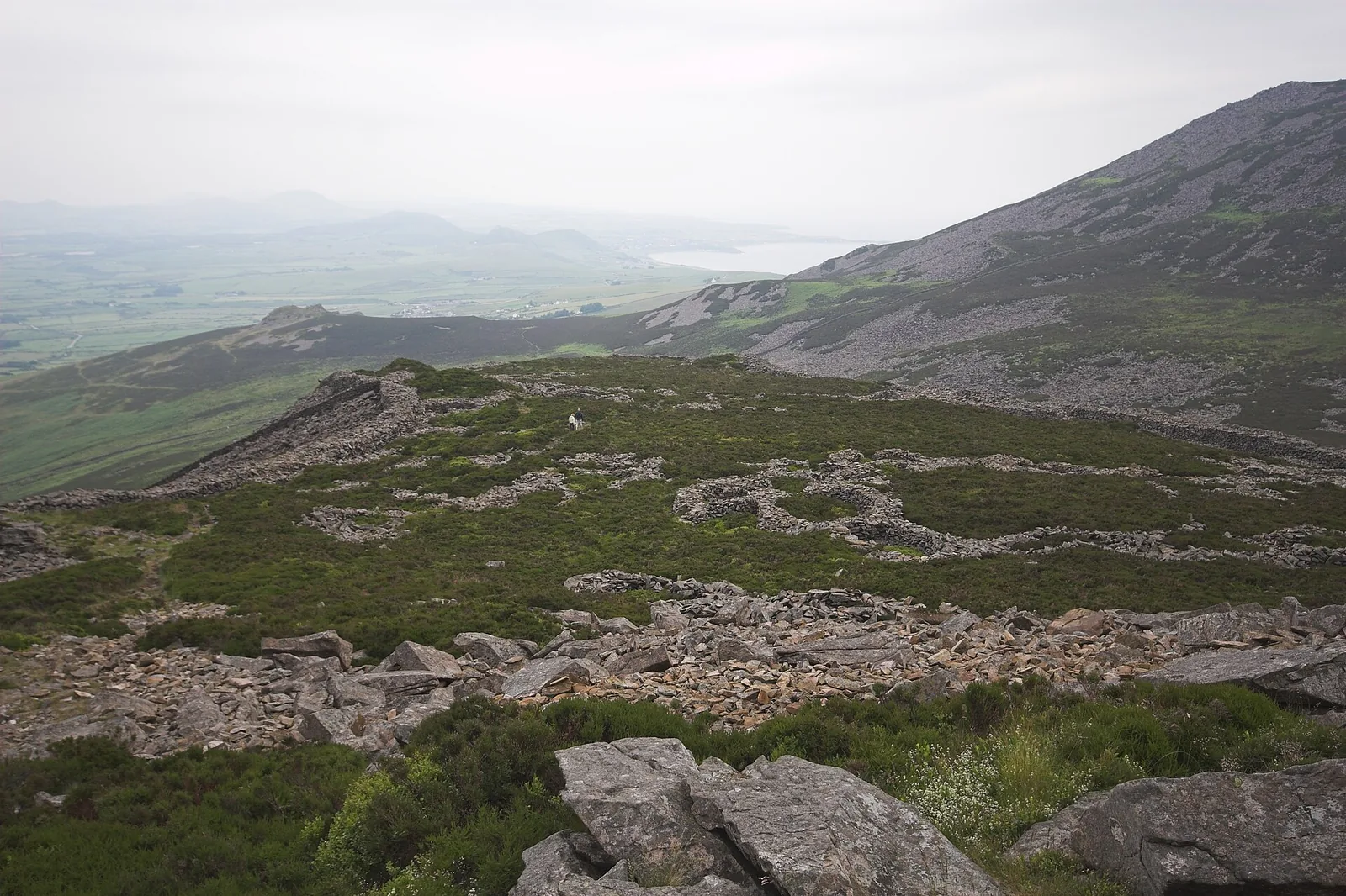 The hut circles of Tre&rsquo;r Ceiri spread across the eastern top of Yr Eifl