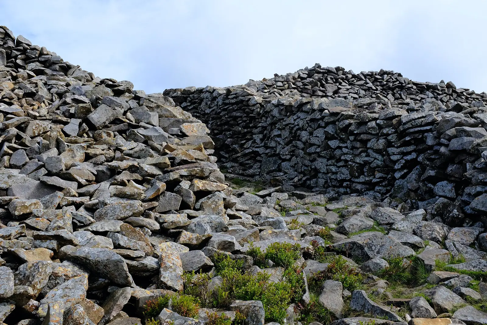 The stone rampart of Tre&rsquo;r Ceiri standing head-high beside an entrance gap