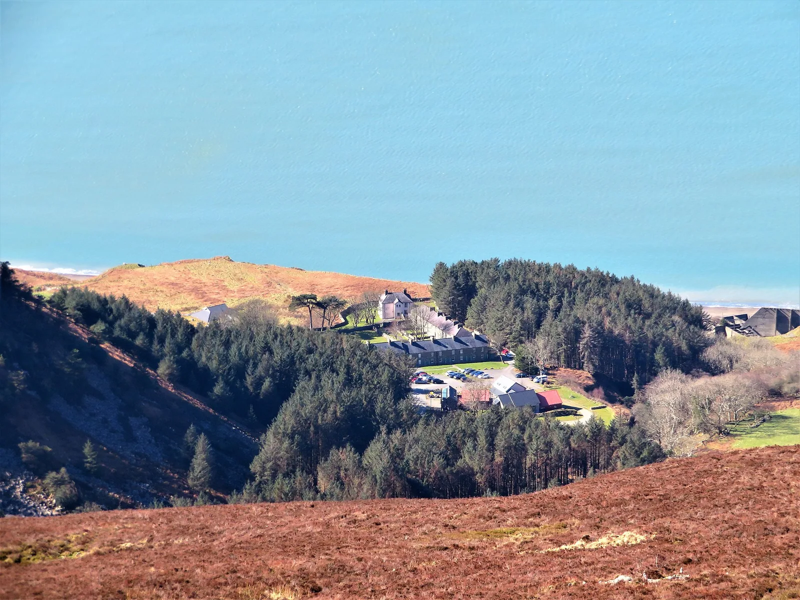 Nant Gwrtheyrn, the former quarry village, in its wooded cwm below Garn Ganol