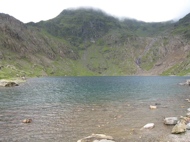 Glaslyn lake with the base of Snowdon rising into low mist