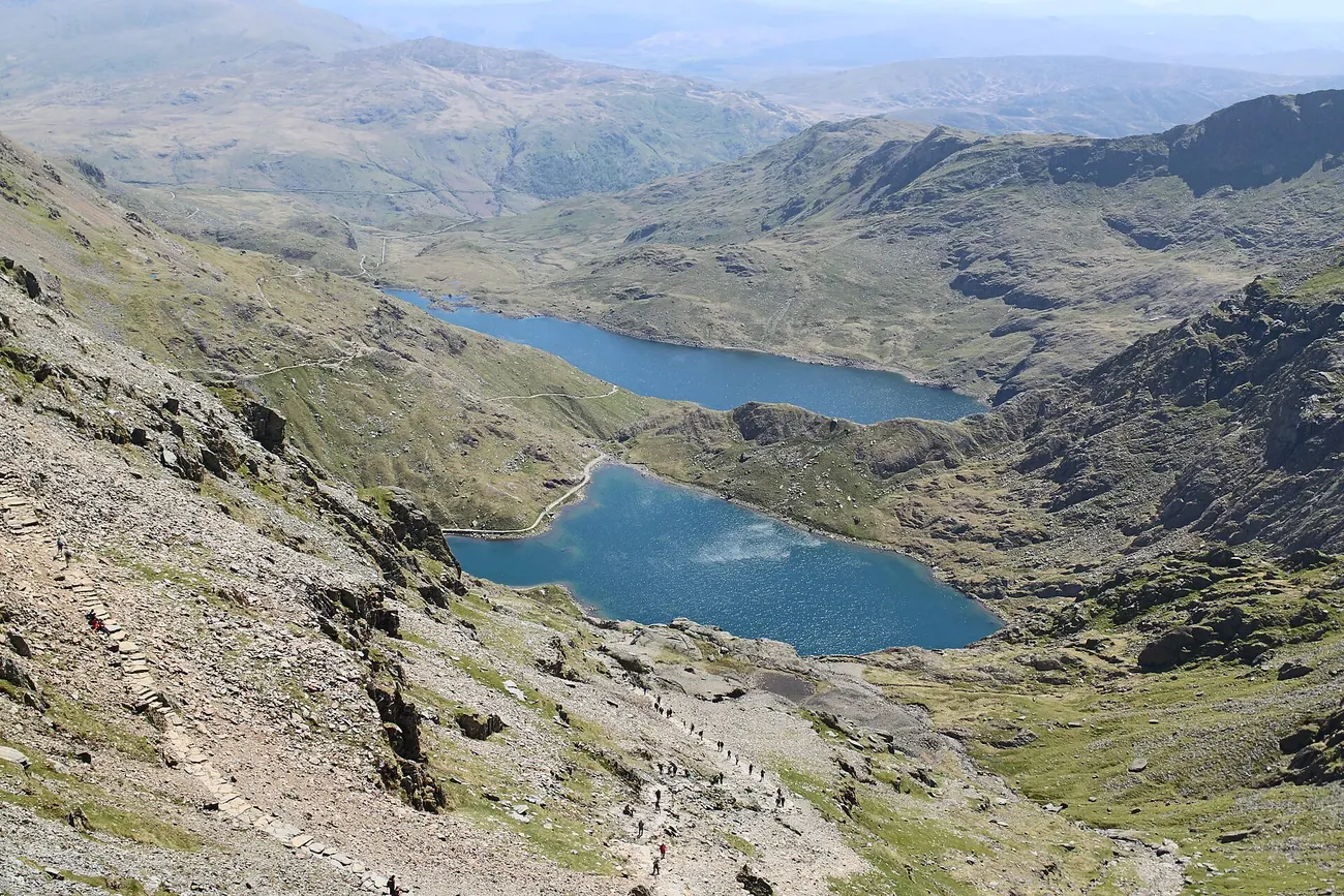 The view from the PYG Track high on Yr Wyddfa (Snowdon), looking down over the lakes of Llyn Llydaw and Glaslyn to the ridges and passes of Eryri, Gwynedd.